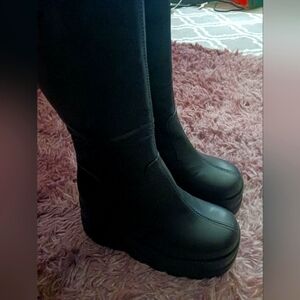 Long Black faux leather platform boots with side zipper just about knee high.
